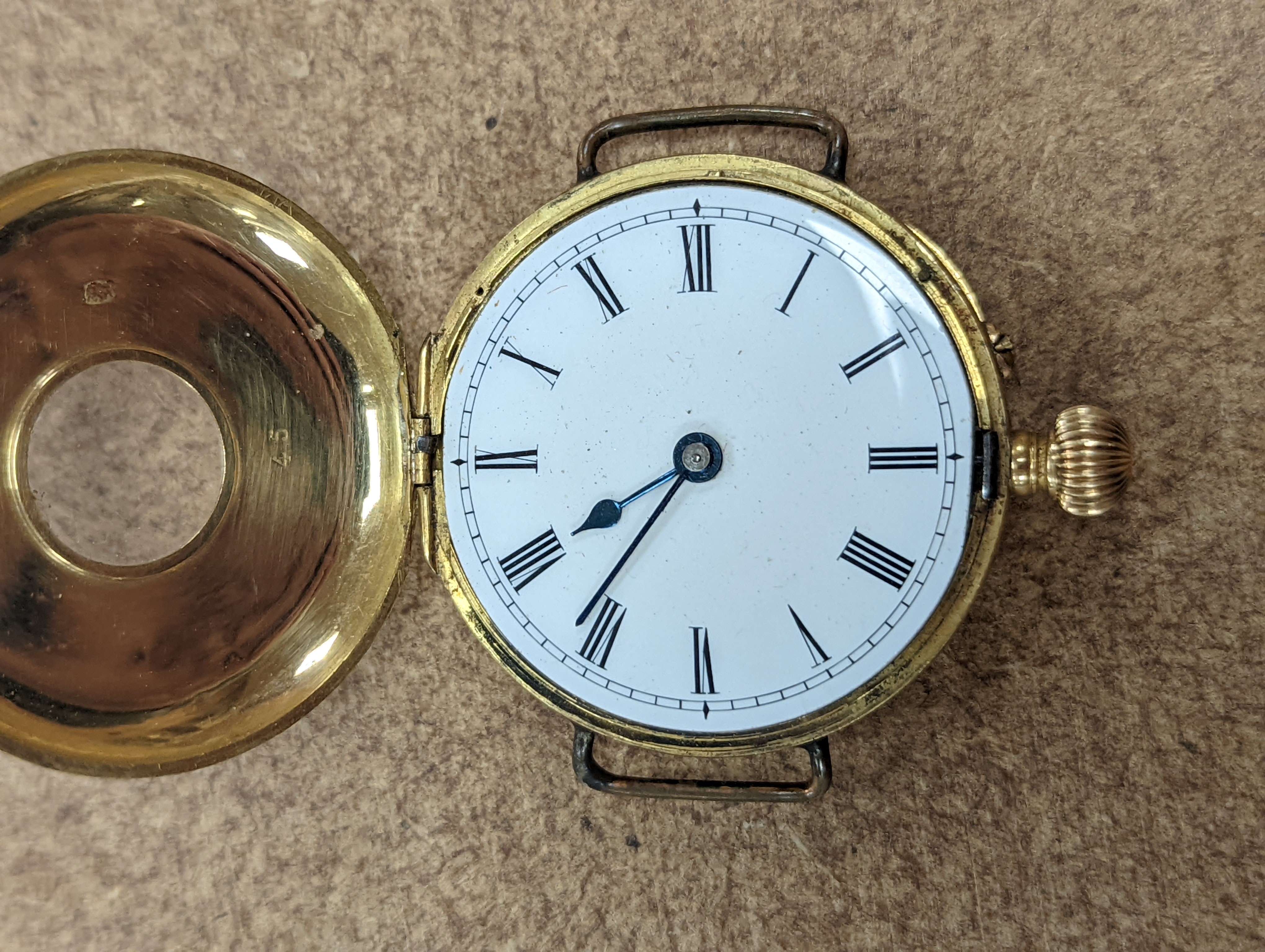 A gentleman's early 20th century continental 18k half hunter wrist watch, case diameter 33mm, gross weight 32.7 grams, together with two other silver watches.